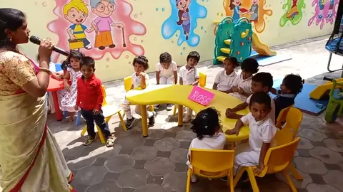 Wide view of the outdoor activity yard with tables and painted walls