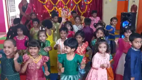 Children dancing together in festival dress