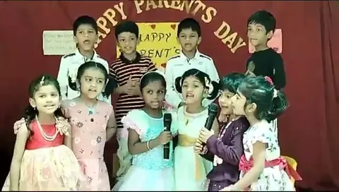 Parents Day group photograph on the school stage